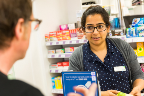 Pharmacist speaking to patient in hospital