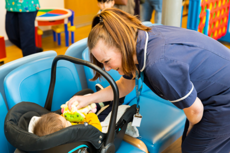 Nurse playing with baby
