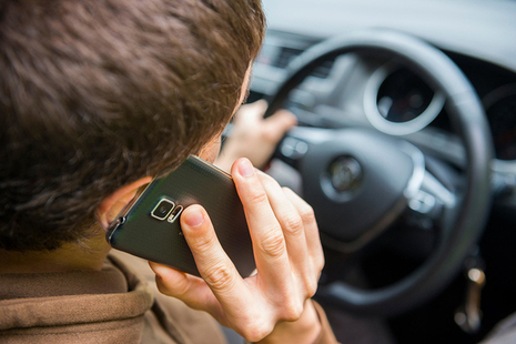 Picture of driver talking on a mobile phone while driving.