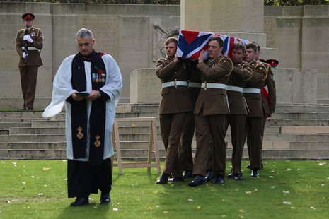 Reverend Paul Whitehead leads the soldiers from the 1st Battalion The Royal Anglian Regiment as they carry Lance Corporal Perkins to his final resting place