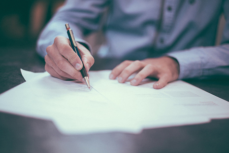 Person writing at a desk