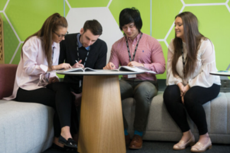 Four HM Land Registry team members working at a desk