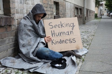 Man begging on the street - looking for human kindness
