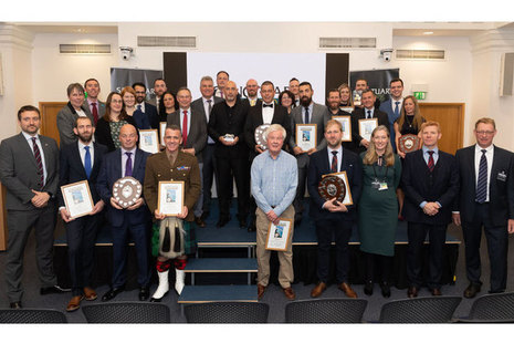 Sanctuary Award winners celebrate at awards ceremony (Crown Copyright, MOD 2019). A picture of winners holding awards.