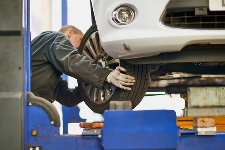 Photo of an MOT tester testing