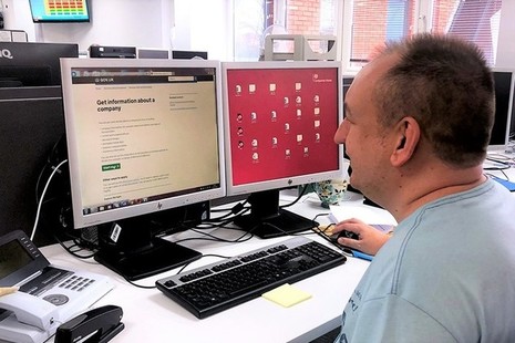 Companies House employee at work in front of a computer screen.
