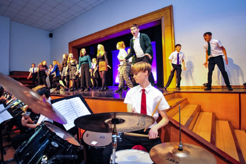 Children on stage and boy playing drums 