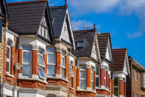 A row of red brick terraced houses in London.