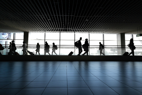 people walking along inside an airport