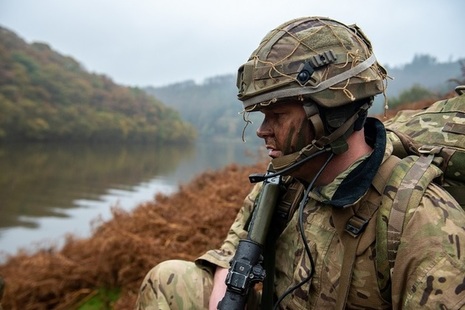 Soldier looking across a wet gap