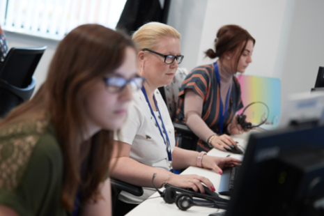 3 people viewing computers