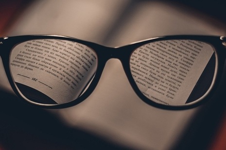 Spectacles hovering over book