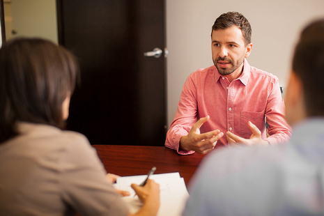 Man being interviewed in an office - Read our latest blog on working as an Examiner in the insolvency Service