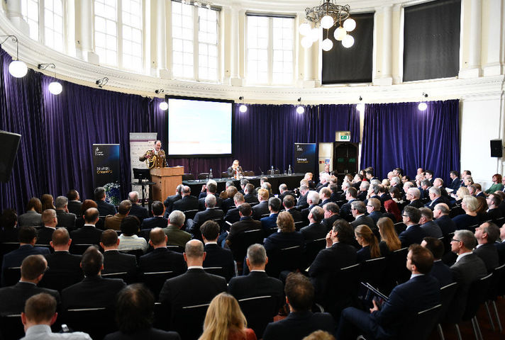 Picture of the Inaugural Strategic Command RUSI Conference with a military commander speaking at a podium in front of a seated audience.