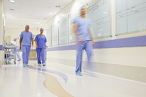 Doctors walking along a hospital corridor