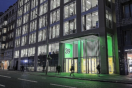 The Department of Health and Social Care viewed from the street, lit up green