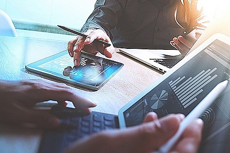Business team with various screens showing graphs