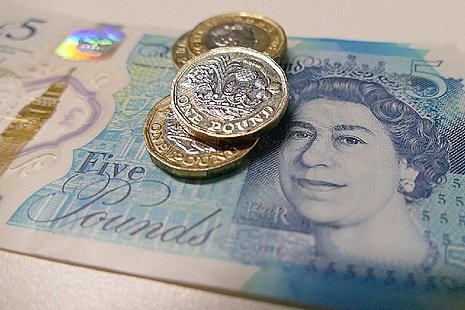 Image of a five pound note and several pound coins.