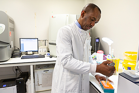 Lab assistant performing test in NHS laboratory