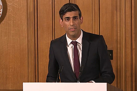 Chancellor Rishi Sunak delivering a coronavirus update at podium
