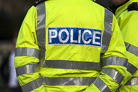Cropped image of police officer from behind