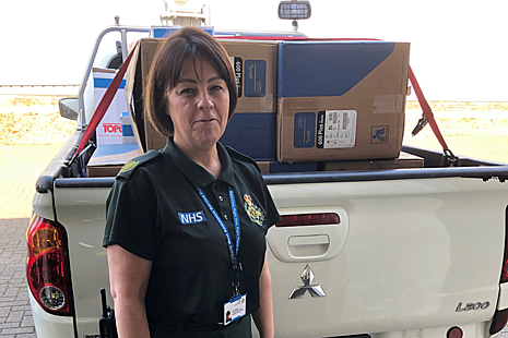 Senior Manager NW Ambulance Service standing in front of van of PPE donated by LLWR