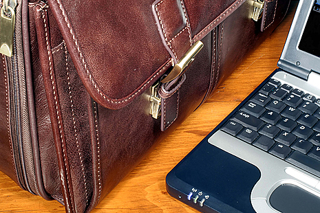 Laptops and Briefcase on desk