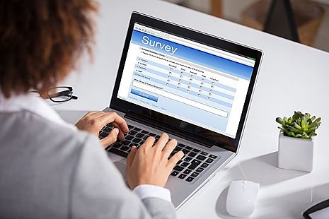 Woman filling in survey on laptop