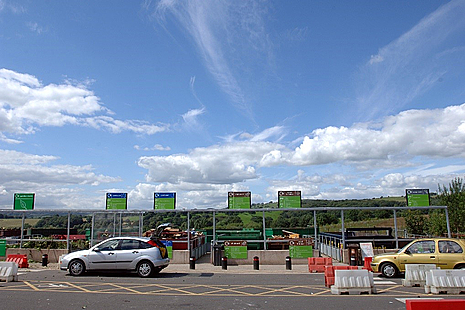 A photo of a number of large skips at a household waste and recycling centre