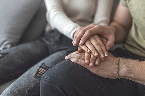 Two people holding hands