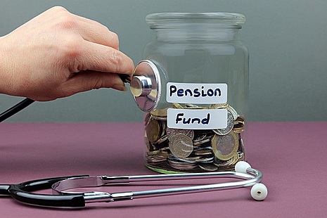 Stethoscope against a jar of money with pension fund label