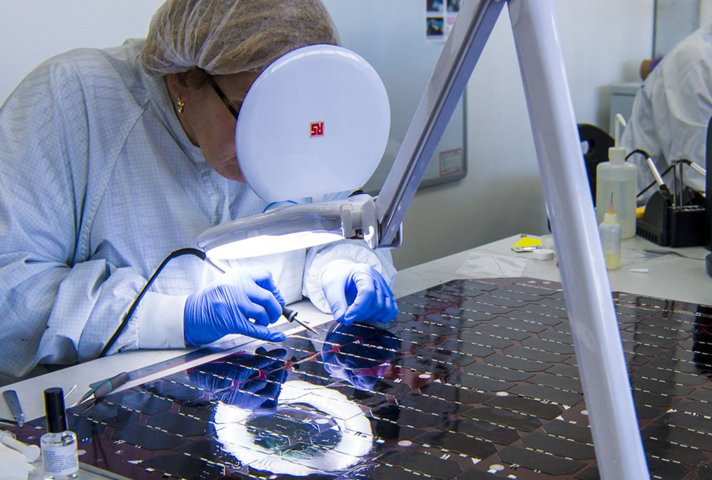 A worker with spacecraft solar panel