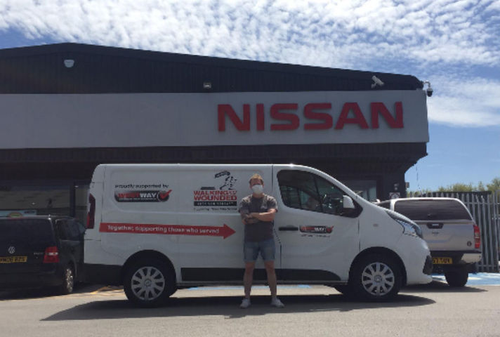 The new Nissan NV300 for the Walking With the Wounded charity van and a man standing in front of looking straight at the camera