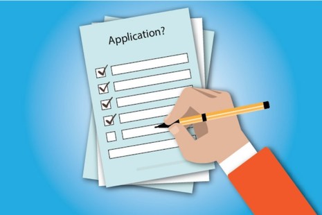 picture of hand holding a pen completing an application