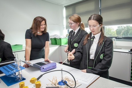Teacher and pupils in science lab