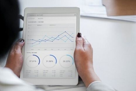Businesswoman looking at a chart on a tablet.