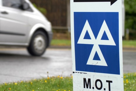 Photo of an MOT centre sign at the roadside.
