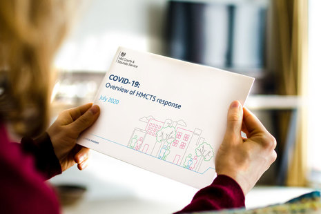 Image of someone holding the recovery plan document sitting by desk