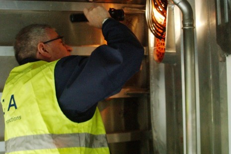 Surveyor inspecting light fitting