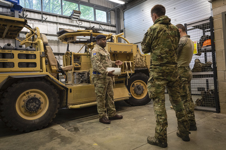 Estonian troops receive instruction from a British Army soldier