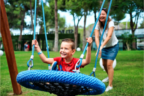 boy swings as woman pushes