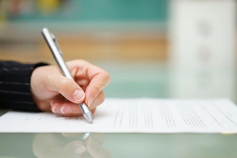 Stock image of a person working at a desk.