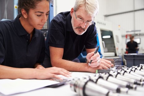 Image of an apprentice working with a tutor.