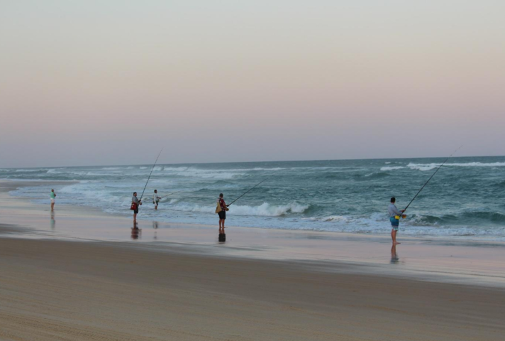 people fishing on beach