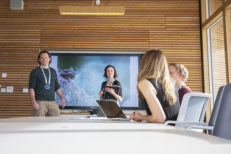 Four staff members in a meeting at UKHO