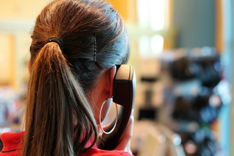 Headshot of woman talking on telephone