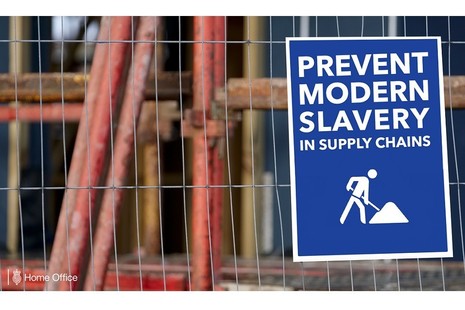 Sign on a fence reading "Prevent modern slavery in supply chains"