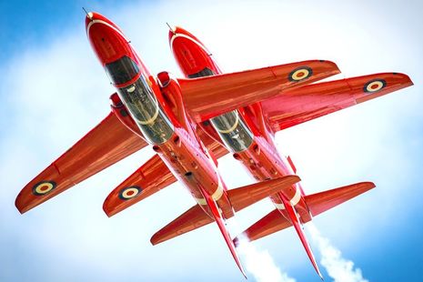 Pictured are two aircraft of the Red Arrows Aerobatic Team flying The Synchro Pair.