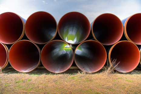 Stack of pipes on ground ready for use