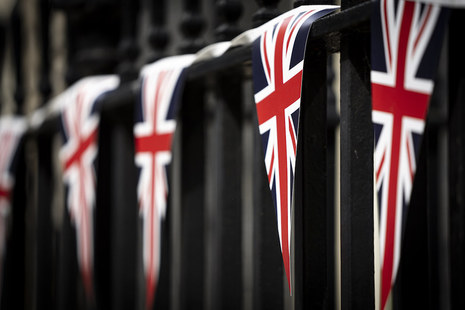 5 triangular Union Jack flags hanging on some railings